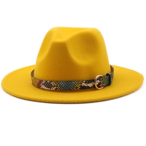 Detail of yellow wool fedora hat featuring a stylish snake skin leather band and gold buckle