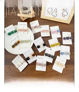 Close-up of cat-shaped acetate hair clips with glitter finish on display card