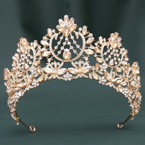 Detailed close-up of golden Baroque crown with champagne crystals and floral metal patterns