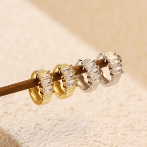 Detailed view of silver and gold S925 hoop earrings with rectangular cubic zirconia stones