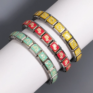 Detail of stainless steel zodiac charms on Italian bracelet with colorful enamel finish