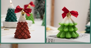 Detailed close-up of Christmas tree scented candles with red bows and golden bells