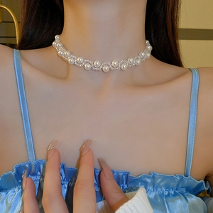 Detail of French vintage faux pearl and crystal choker necklace on model's neck