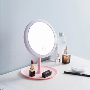 Pink desktop LED makeup mirror with round touch screen and integrated base storage tray