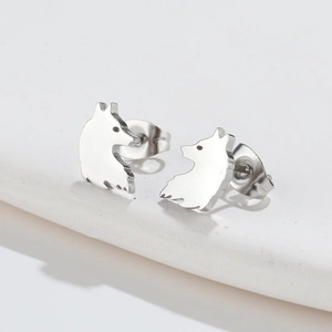 Macro side view of silver wolf animal stud earrings made of polished stainless steel