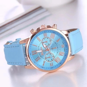 Detailed close-up of light blue Geneva quartz watch with rose gold case and leather strap
