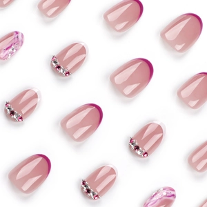 Pink French style press-on nails with rhinestone accents and marble texture design