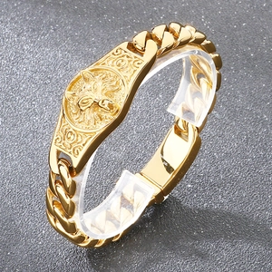 Detailed macro view of 316L gold stainless steel cuban link bracelet with wolf head medallion