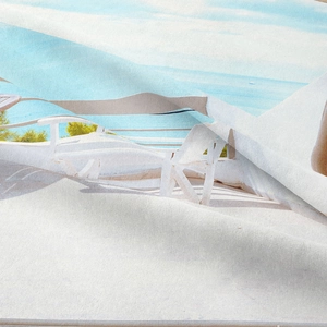 Detailed macro view showing the soft fabric texture and beach scene print on the tapestry