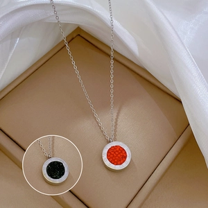 Detail of Roman numeral circular pendant necklace with red and black center inserts
