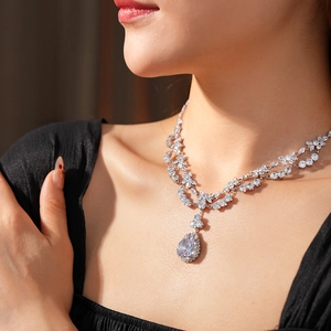Close-up of luxury teardrop pendant necklace with sparkling cubic zirconia on a model