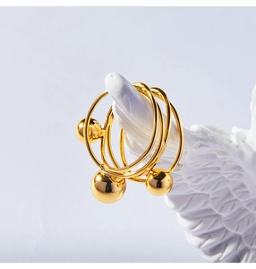 Detail of French vintage gold layered ring with beads on a white statue hand