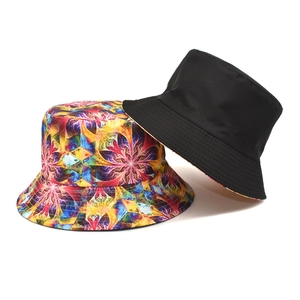 Double-sided tie-dye bucket hat with colorful floral print and solid black reverse side
