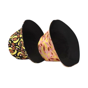 Double-sided reversible bucket hat featuring tropical banana and papaya patterns in black and pink