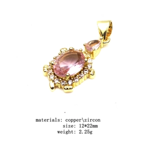 Macro shot of gold-plated turtle pendant with pink zircon and size specifications