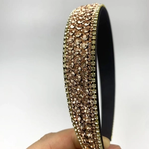 Close-up of champagne rhinestones and black non-slip lining on a luxury headband