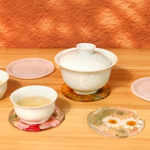 Detailed view of handmade clear resin coasters with embedded natural dried flowers