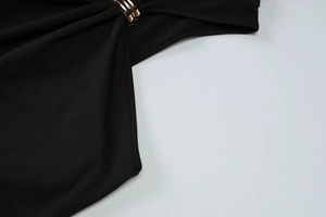 Close-up of golden metal buckle and knit fabric on high waist sleeveless dress
