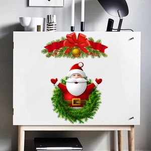 Detailed view of Santa Claus and holly branch stickers applied on a white cabinet door