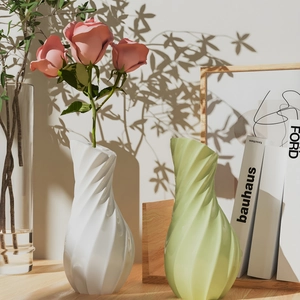 Modern spiral textured vases in white and green shown as stylish home decor items