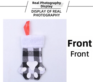Detailed view of cat paw Christmas stocking with black and white plaid and plush cuff