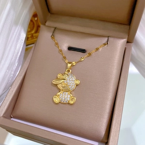 Detail of a gold bear pendant with sparkling zircon stones in a jewelry box