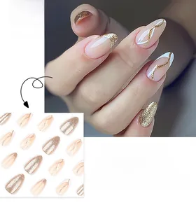 Macro detail of almond press-on nails featuring golden glitter and wavy line patterns