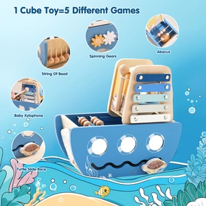 Close-up of wooden boat toy featuring xylophone, bead maze and colorful gears