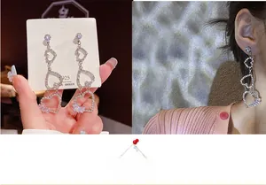 Detail of luxury heart tassel earrings with S925 silver needle and sparkling rhinestones