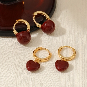 Detail of vintage red enamel heart and ball pendants on gold hoop earrings set