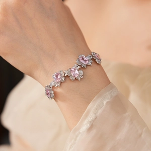 Detail of silver flower bracelet with pink gemstones and clear zircons on wrist