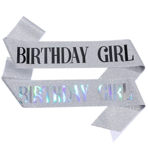 Silver glitter birthday girl sashes with black and holographic lettering on white backdrop