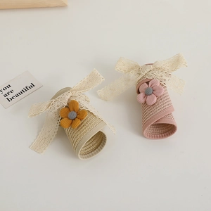 Foldable children's straw sun visors with lace trim and bow decorations in cream and pink