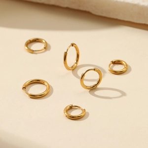 Minimalist gold stainless steel hoop earrings set of 6 in various sizes on stone base