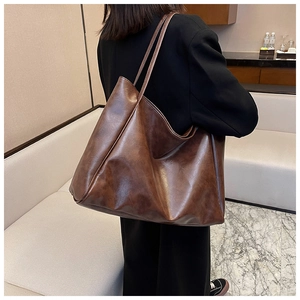 Woman wearing large vintage dark brown PU leather tote bag with long double straps