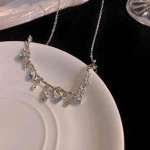 Elegant irregular geometric teardrop fringe necklace with light blue stones in silver
