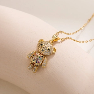 Close-up of golden movable bear necklace pendant with multicolor micro-pave zircons