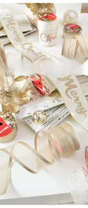 Detail of luxury champagne Merry Christmas velvet ribbon with gold glitter and snowflake patterns