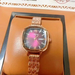Macro detail of luxury square quartz watch with rose gold strap and purple gradient dial