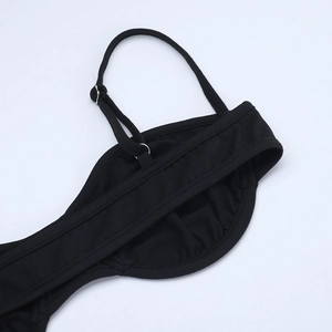 Close-up of black lace camisole adjustable shoulder strap with metal buckle detail
