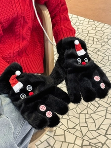 Detail of black plush snowman mittens with red hats and checkered buttons