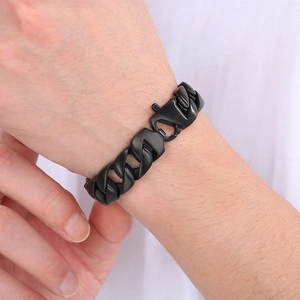 Detailed close-up of 15mm black Cuban link chain bracelet on a male wrist