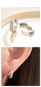 Detail of silver opal hoop earrings with white and blue iridescent synthetic stones