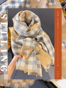 Detail of floral plaid cashmere-like scarf with thick fringe edge for winter warmth