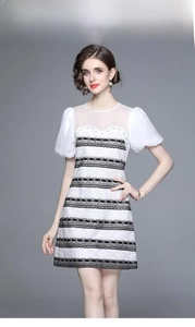 Detail of puff sleeves and ivory mesh patchwork on this black and white A-line dress