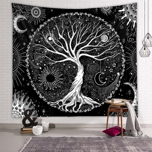 Close-up of bohemian tree of life tapestry with sun and moon icons on white brick wall