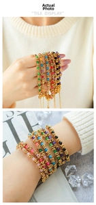 Detail of colorful beaded gold-plated bracelets showing faceted beads and twisted metal chain