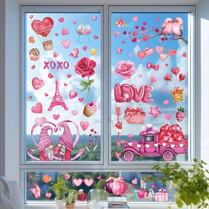 Close-up of Valentine's Day gnome window decals with heart truck and pink Eiffel Tower