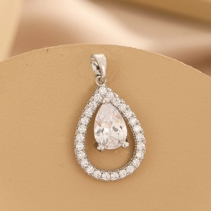 Elegant silver teardrop necklace with pear-cut zircon and halo stones on beige background