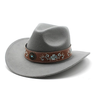 Detail of grey felt cowboy hat featuring embroidered leather band and turquoise stud